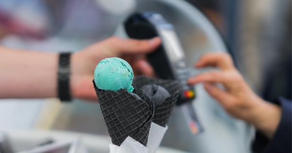 Closeup Of Icecream In Black Waffle Cones Hands Of Customer Paying A Picture Id692805088